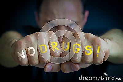 NO DRUGS written on an angry manâ€™s fists Stock Photo